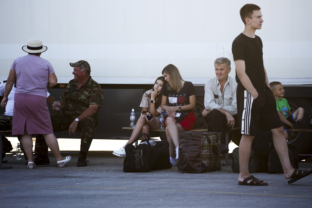 People wait for a ferry to Crimea near the village of Ilyich, Krasnodar region of Russia, on Monday, July 17, 2023. An attack before dawn Monday damaged part of a bridge linking Russia to Moscow-annex ...