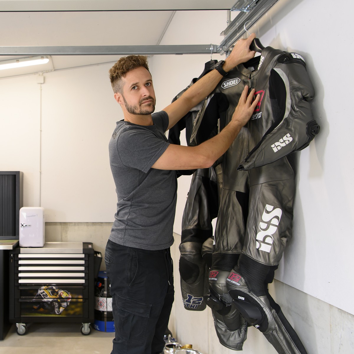 Swiss motorcycle racer Thomas "Tom" Luethi, hangs his motorcycle suits during a media appointment at his home in Linden, Switzerland, on Thursday, August. 19 2021. Luethi is retiring at the  ...