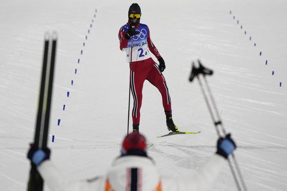 Norway&#039;s Joergen Graabak celebrates as he nears the finish line during the cross-country skiing competition of the team Gundersen large hill/4x5km at the 2022 Winter Olympics, Thursday, Feb. 17,  ...