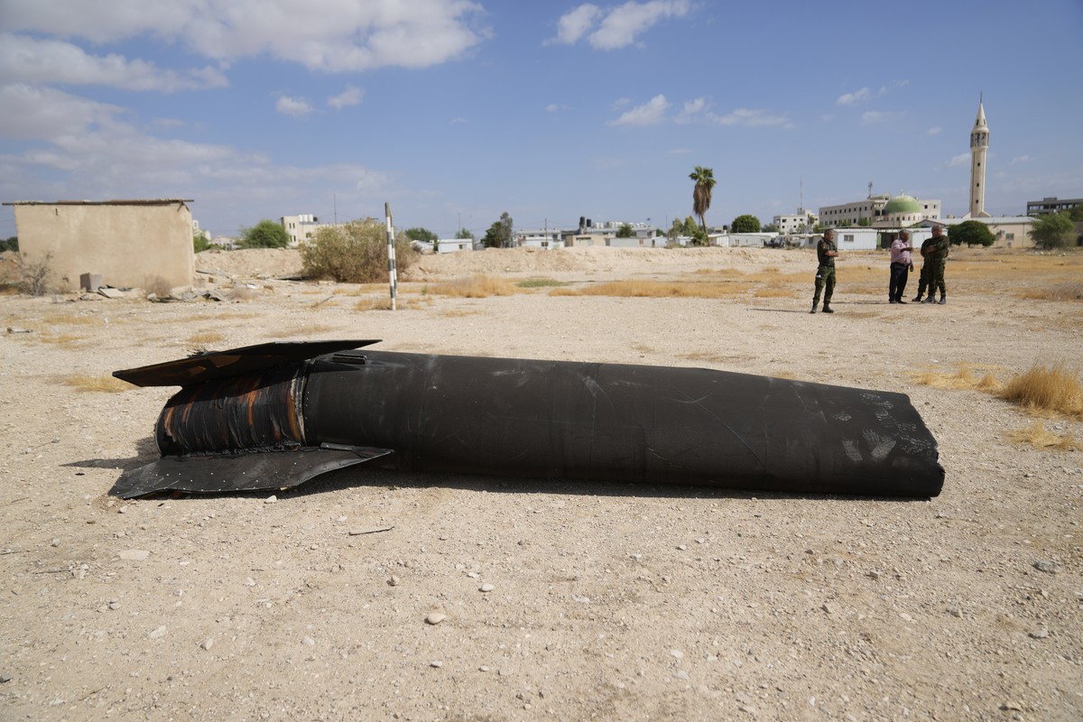 Officers from the Palestinian National forces inspect part of a rocket, launched during Iran's strike against Israel, at a facility of their unit in the West Bank city of Jericho, Wednesday, Oct. ...