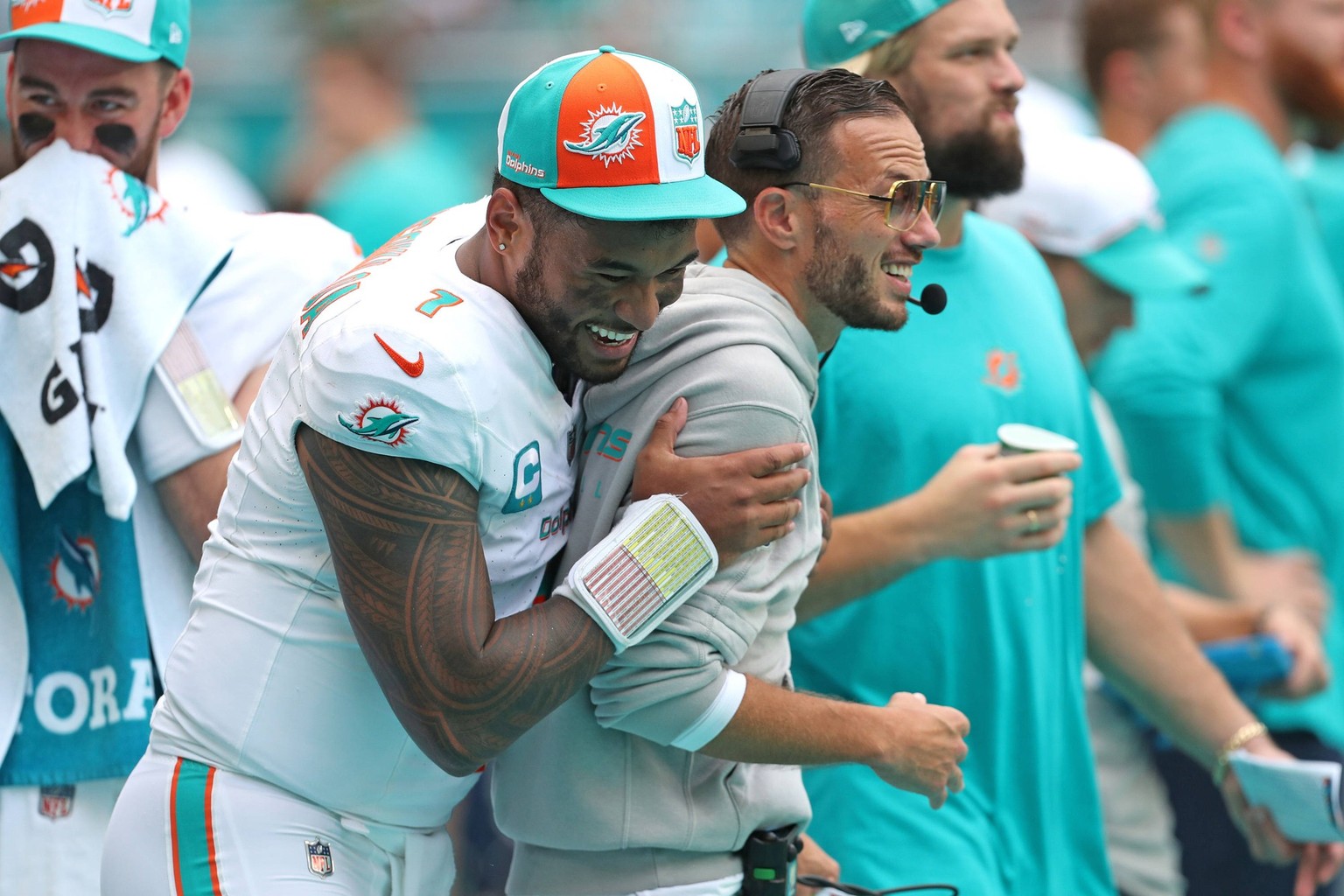 September 25, 2023, Miami Gardens, Florida, USA: Miami Dolphins quarterback Tua Tagovailoa laughs with head coach Mike McDaniel during the game against the Denver Broncos at Hard Rock Stadium on Sunda ...