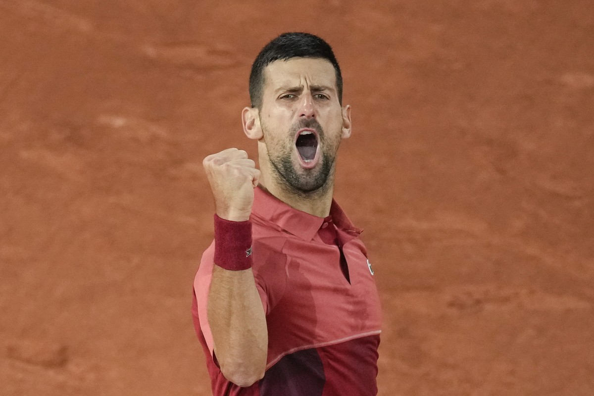 Serbia's Novak Djokovic clenches his fist after scoring a point against France's Pierre-Hugues Herbert during their first round match of the French Open tennis tournament at the Roland Garro ...