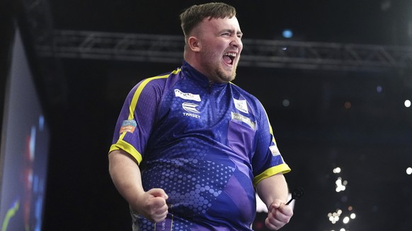 Luke Littler celebrates victory in the final against Luke Humphries during the Darts Premier League play-off at The O2, London, Thursday, May 23, 2024. (Zac Goodwin/PA via AP)