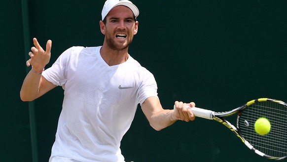 epa06070393 Adrian Mannarino of France in action against Yuichi Sugita of Japan during their second round match for the Wimbledon Championships at the All England Lawn Tennis Club, in London, Britain, ...