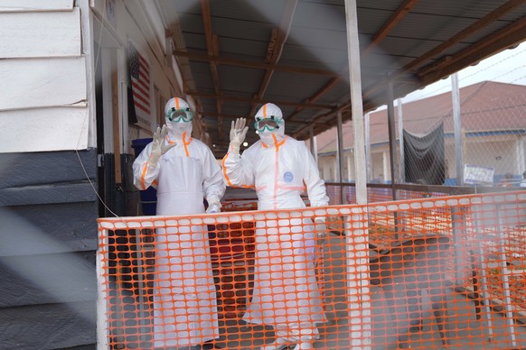 Health workers in protective gear wave inside an Ebola treatment centre in Bunia, Congo, Monday, Aug. 10, 2026. (AP Photo/Dieudonne Dirole)
Congo Ebola