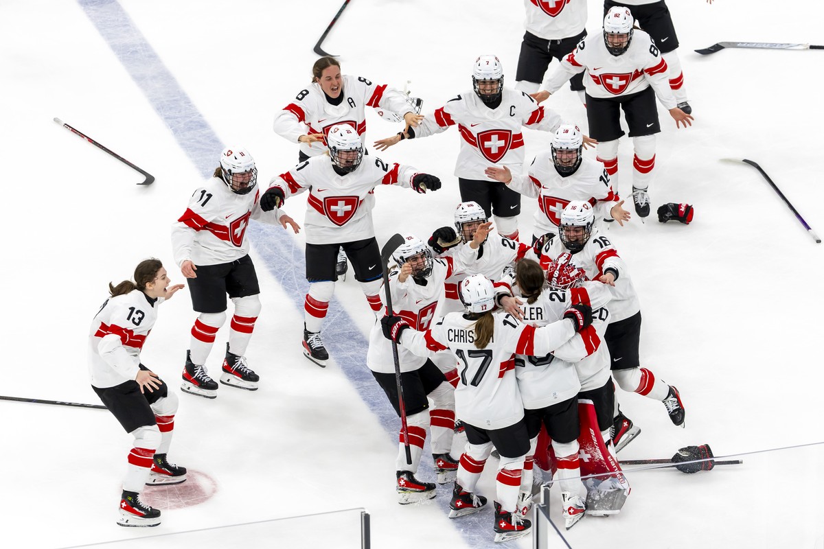 Switzerland's Alina Muller #25 celebrates her game winner goal with teammates, during the overtime of the ice hockey women's bronze medal game between Switzerland and Sweden at the 2026 Olym ...