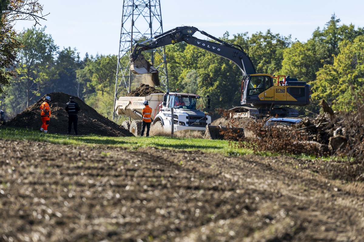 KEYPIX - Des ouvriers travaillent sur le chantier de l'autoroute A412 sour le regard d'un agent de securite, ce lundi 12 octobre 2026 a Bons-en-Chablais (France). L'A412 est un projet d ...