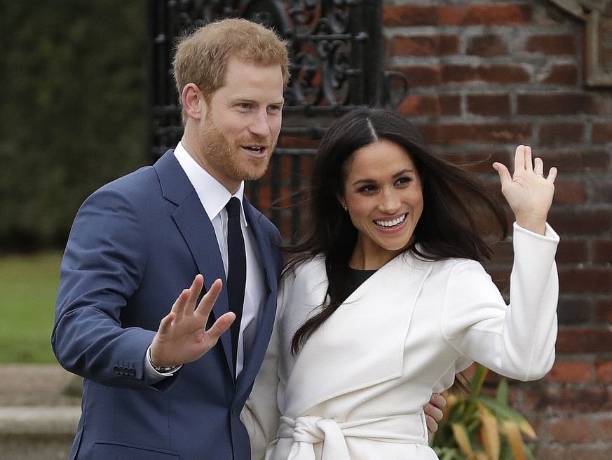 FILE - In this Monday, Nov. 27, 2017 file photo, Britain&#039;s Prince Harry and his fiancee Meghan Markle pose for photographers during a photocall in the grounds of Kensington Palace in London. Prin ...