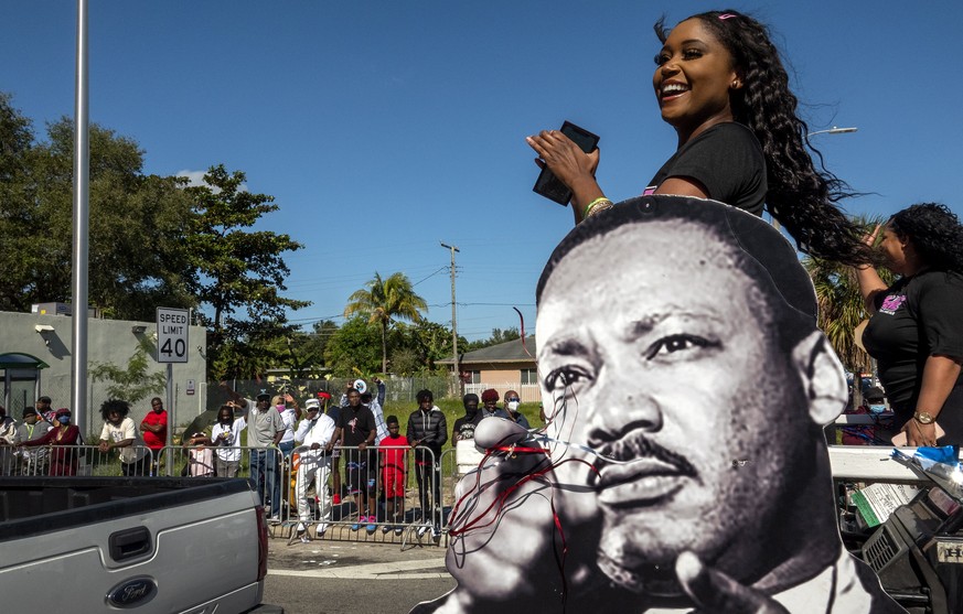epa09691654 People participate in the Martin Luther King Jr parade in Miami, Florida, USA, 17 January 2022. The Miami?s MLK parade is annually organized by the MLK Day Parade and Festivities Committee ...