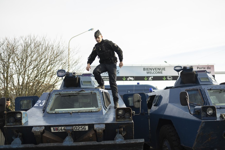 epa11112316 French Police armored vehicles are stationed at the entrance of Rungis city, near Paris, France, 29 January 2024. French farmers continue their protests with road blockades and demonstrati ...