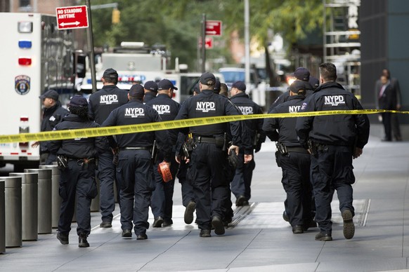 NYPD officers depart from the Time Warner Center area on Wednesday, Oct. 24, 2018, in New York. Law enforcement officials say a suspicious package that prompted an evacuation of CNN&#039;s offices is  ...