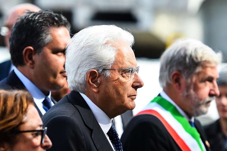 epa07772573 Liguria Region Governor Giovanni Toti (L), Italian President Sergio Mattarella (C) and Genoa Mayor Marco Bucci (R) attend the memorial ceremony for the victims on the first anniversary of  ...