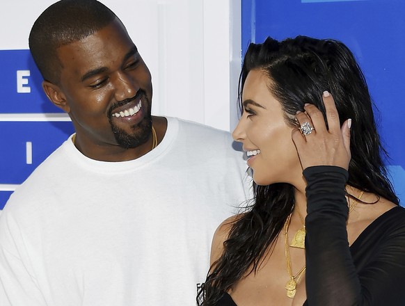 FILE - In this Aug. 28, 2016 file photo, Kanye West, left, and Kim Kardashian West arrive at the MTV Video Music Awards in New York. Armed robbers forced their way into a private Paris residence early ...