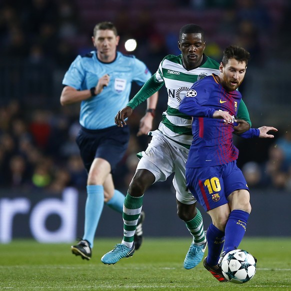 Barcelona&#039;s Lionel Messi, right, and Sporting&#039;s William Carvalho challenge for the ball during the Champions League Group D soccer match between FC Barcelona and Sporting CP at the Camp Nou  ...