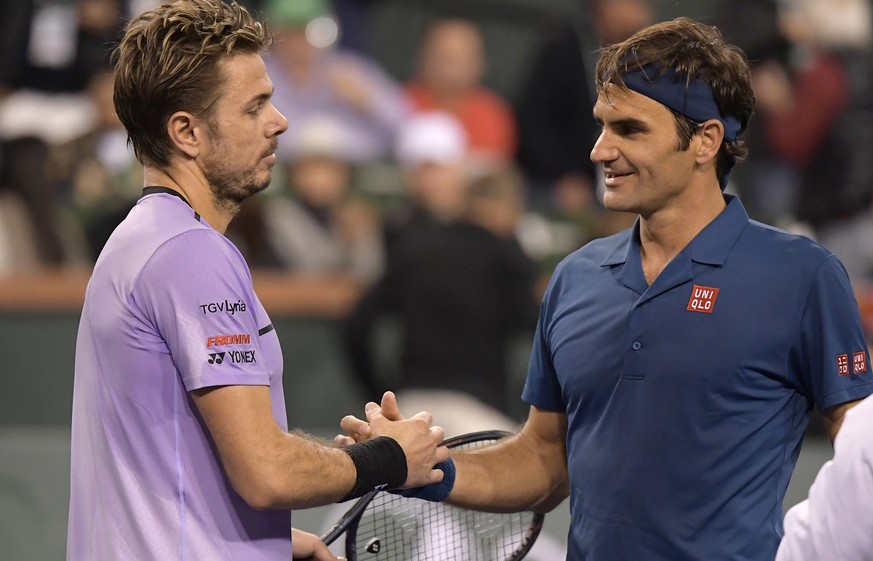 Stan Wawrinka left, congratulates Roger Federer at the BNP Paribas Open tennis tournament Tuesday, March 12, 2019 in Indian Wells, Calif. (AP Photo/Mark J. Terrill)