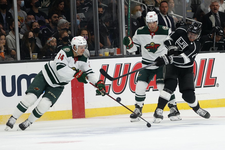 Minnesota Wild forwards Kevin Fiala (22) looks on as Joel Eriksson Ek (14) defends against Los Angeles Kings forward Anze Kopitar (11) during the first period of an NHL hockey game Saturday, Oct. 16,  ...