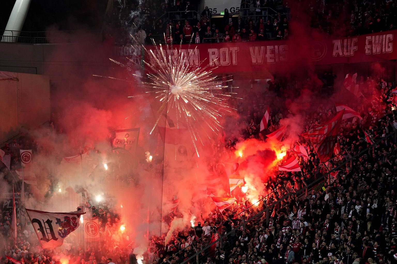 Duesseldorf fans cheer their team during the German soccer cup match between Bayer 04 Leverkusen and Fortuna Duesseldorf in Leverkusen, Germany, April 3, 2024. (AP Photo/Martin Meissner)