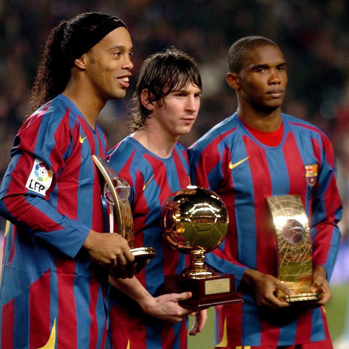 FC Barcelona's players Brazilian Ronaldo de Assis Moreira 'Ronaldinho' (L), Argentinian Lionel Messi (C) and Samuel Eto'o, from Cameroon, pose with their trophies as FIFA World Pla ...
