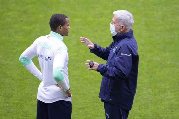 epa08723771 Switzerland's national soccer head coach Vladimir Petkovic speaks to defender Manuel Akanji (L) during the team's training session at the kybunpark stadium in St. Gallen, Switzer ...
