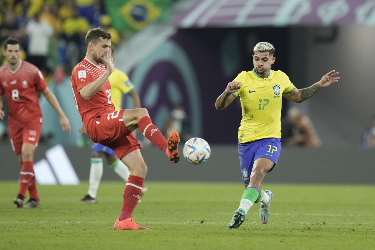 Brazil's Bruno Guimaraes, right, and Switzerland's Fabian Frei challenge for the ball during the World Cup group G soccer match between Brazil and Switzerland at the Stadium 974 in Doha, Qat ...