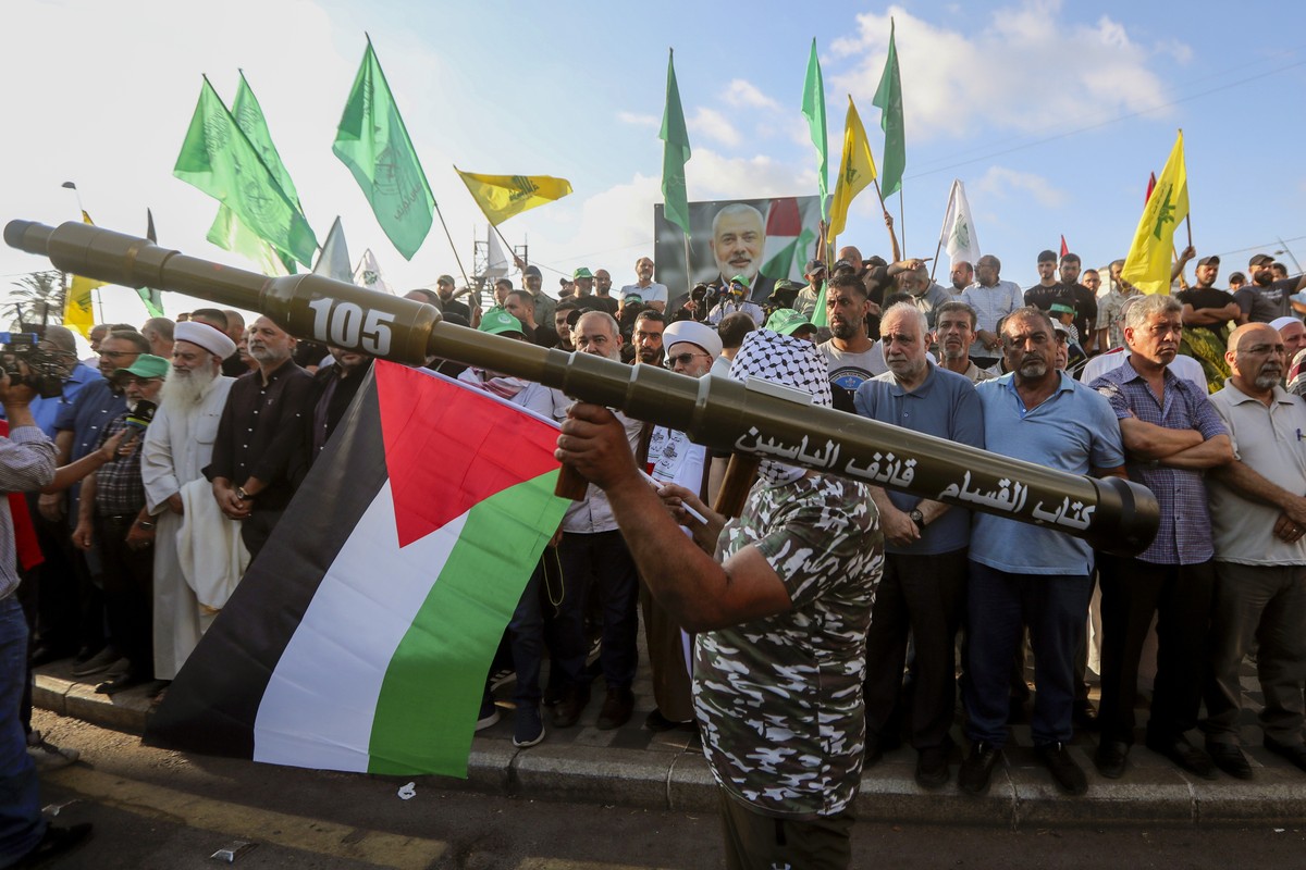 A supporter of the Lebanese Islamic group and the Islamist Hamas movement holds a mock rocket as he attends with other supporters a protest to condemn the killing of Hamas political chief Ismail Haniy ...
