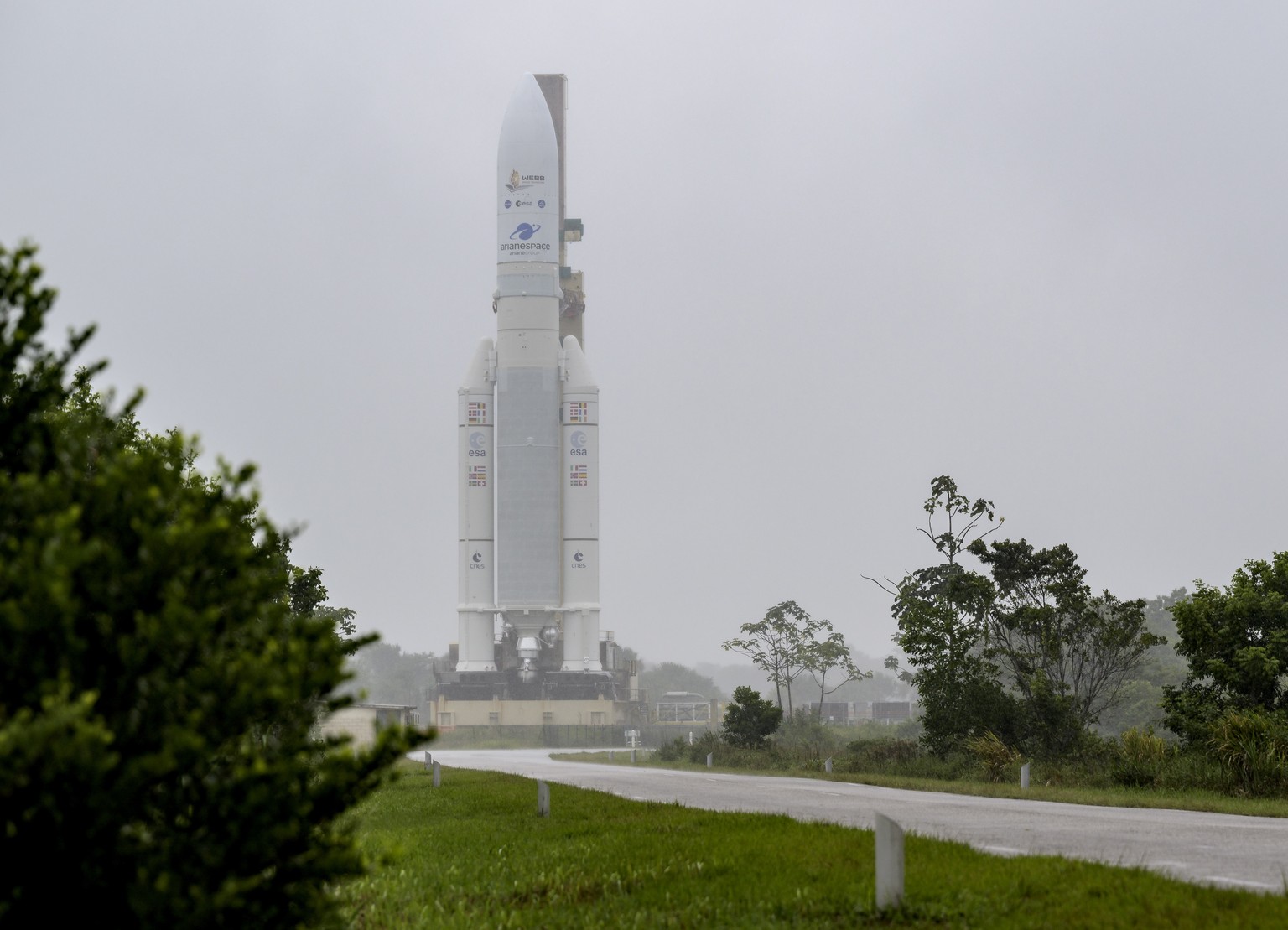 epa09655209 A handout photo made available by NASA shows Arianespace&#039;s Ariane 5 rocket with NASA?s James Webb Space Telescope onboard, being rolled out to the launch pad, at Europe?s Spaceport, t ...