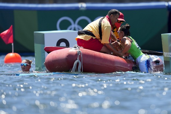 Spela Ponomarenko Janic, left, and Anja Osterman of Slovenia are pulled out of the water after flipping their boat while competing in the women&#039;s kayak double 500m semifinalat the 2020 Summer Oly ...