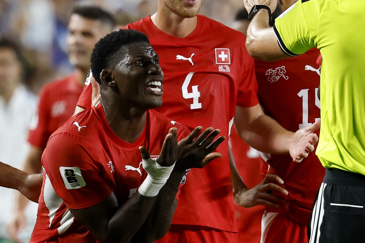 Switzerland's Breel Embolo, left, reacts after referee Joao Pedro Silva Pinheiro, right, sends him off the field with a red card after VAR intervention during the World Cup quarter final match be ...