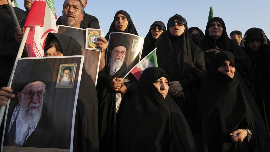 Iranian pro-government demonstrators hold posters of the Supreme Leader Ayatollah Ali Khamenei during their rally condemning recent anti-government protests over the death of Mahsa Amini, a 22-year-ol ...