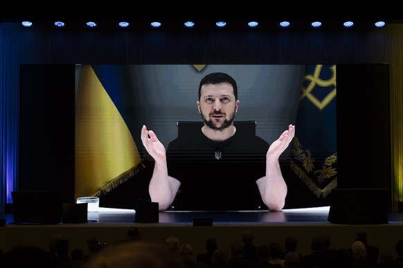 epa10051537 A handout photo made available by Swiss federal Foreign ministry FDFA shows Ukrainian President Volodymyr Zelensky delivers a speech by video conference during the Ukraine Recovery Confere ...