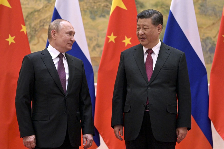 Chinese President Xi Jinping, right, and Russian President Vladimir Putin talk to each other during their meeting in Beijing, China, Friday, Feb. 4, 2022. Putin on Friday arrived in Beijing for the op ...