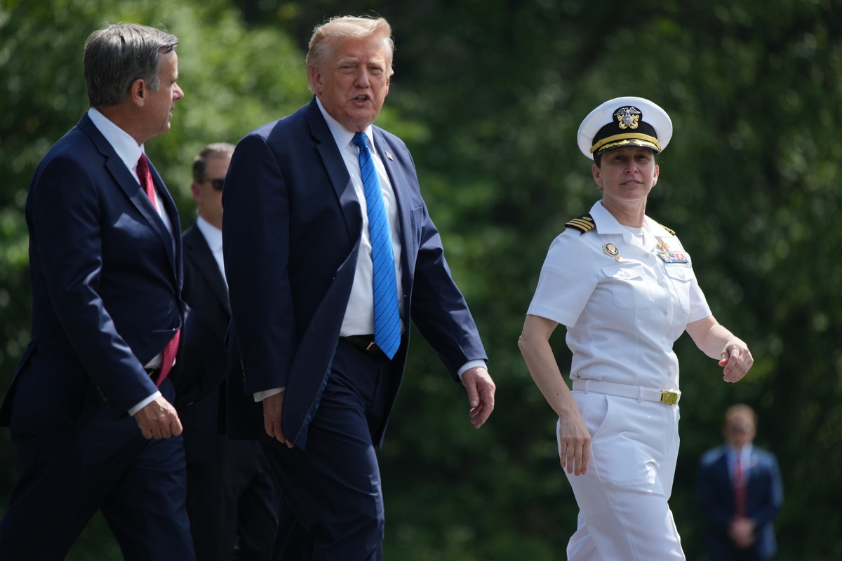 President Donald Trump, center, walks with CIA Director John Ratcliffe before boarding Marine One following a cabinet meeting at Camp David, near Thurmont, Md., Friday, July 31, 2026. (Nathan Howard/P ...