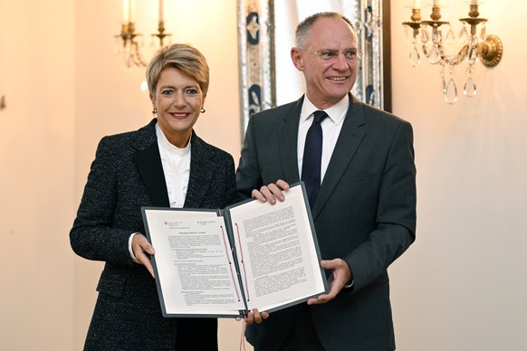 Bundesraetin Karin Keller-Sutter, links, und der oesterreichische Bundesinnenminister Gerhard Karner, rechts, mit der Vereinbarung an einer Medienkonferenz zur Vereinbarung eines Aktionsplans gegen ir ...