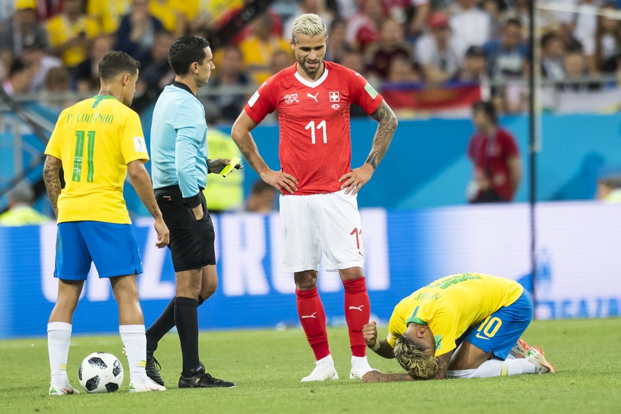 Brazil's midfielder Philippe Coutinho, left, Switzerland's midfielder Valon Behrami, center, react next to Brazil's forward Neymar, right, during the FIFA soccer World Cup 2018 group E ...