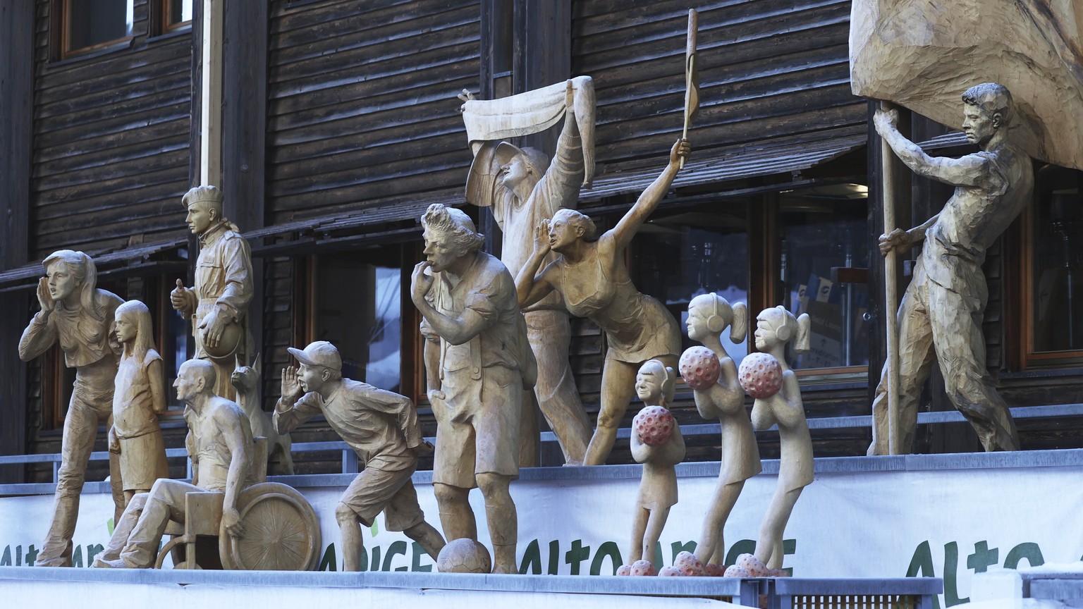 Wooden statues representing cheering fans stand at the finish area during an alpine ski, men&#039;s World Cup super-G, in Val Gardena, Italy, Friday, Dec. 18, 2020. (AP Photo/Alessandro Trovati)