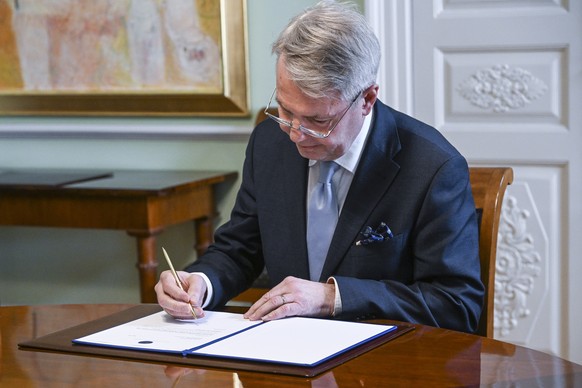 epa09953132 Finnish Foreign Minister Pekka Haavisto signs his country&#039;s application for NATO membership in Helsinki, Finland, 17 May 2022. Finland&#039;s Parliament approved on the day a proposal ...