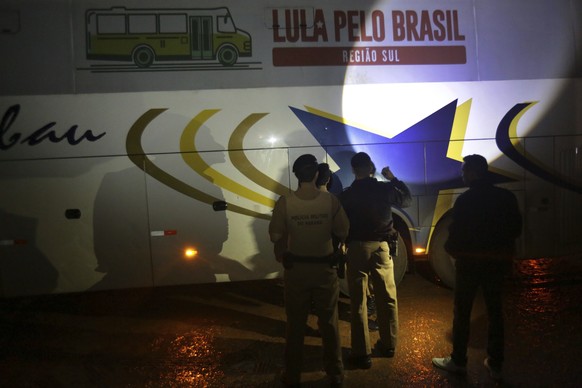 Police investigate a bus used by the campaign caravan carrying Brazil&#039;s former President Luiz Inacio Lula da Silva, at a parking lot in Laranjeiras do Sul, Parana state, Brazil, Tuesday, March 27 ...