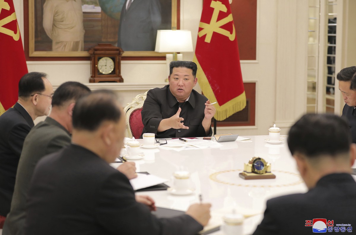 In this photo provided by the North Korean government, North Korean leader Kim Jong Un, center, attends a meeting of ruling party Workers' Labor Party of Korea in Pyongyang, North Korea Tuesday,  ...