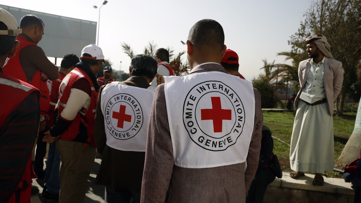 epa10571816 Members of ICRC wait to receive exchanged detainees loyal to the Houthis at Sana'a Airport on the first day of a prisoner swap, in Sana'a, Yemen, 14 April 2023. Yemen's warr ...