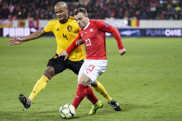 Belgium&#039;s Vincent Kompany, left, fights for the ball against Switzerland&#039;s Xherdan Shaqiri, right, during the UEFA Nations League soccer match between Switzerland and Belgium at the swisspor ...