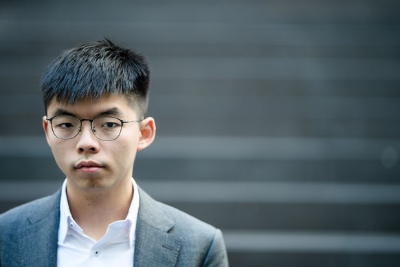 epa07834555 Hong Kong Demosisto party Secretary General and pro-democracy activist Joshua Wong poses for media after a press conference at the Federal Press Conference (Bundespressekonferenz) in Berli ...