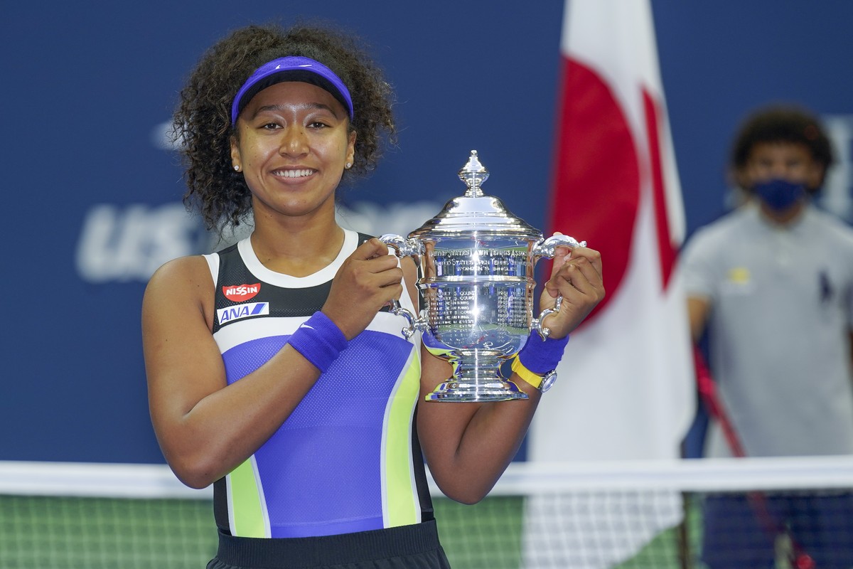 FILE - In this Sept. 12, 2020, file photo, Naomi Osaka, of Japan, holds up the championship trophy after defeating Victoria Azarenka, of Belarus, in the women's singles final of the US Open tenni ...