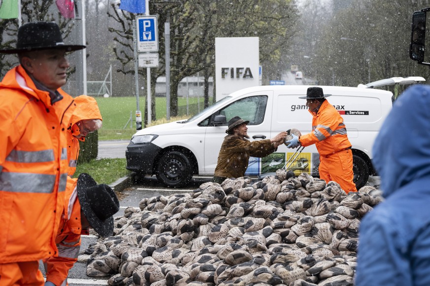 epa09863186 Protestors hold a demonstration on the day of the official draw for the FIFA World Cup Qatar 2022, at the FIFA headquarters in Zurich, Switzerland, 01 April 2022. At dawn, German artist Vo ...