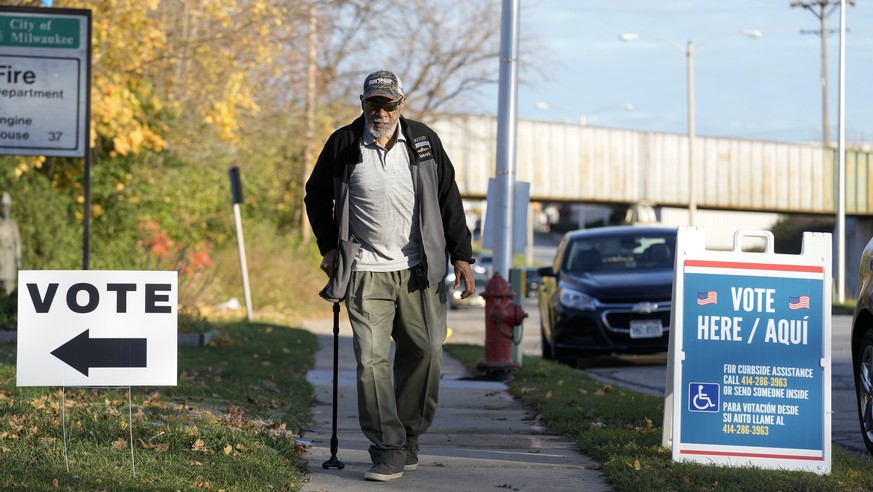 A man makes his way to cast their ballots in the midterm election Tuesday, Nov. 8, 2022, in Milwaukee. (AP Photo/Morry Gash)