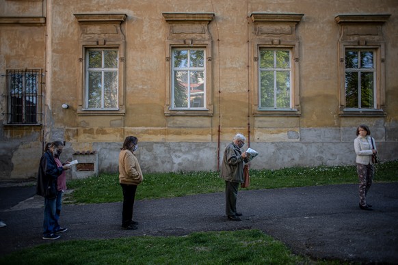 epa08379356 People stand in line for testing for Coronavirus antibodies in Prague, Czech Republic, 23 April 2020. Czech Republic starts voluntary testing for coronavirus antibodies in a few cities acr ...