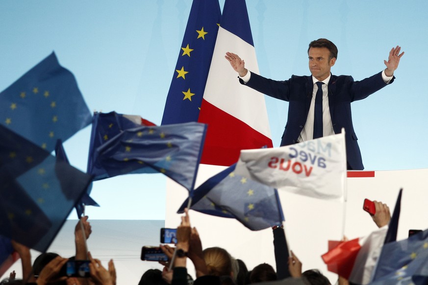 epa09883473 French President and candidate for re-election Emmanuel Macron reacts after results in the first round of the French presidential elections in Paris, France, 10 April 2022. According to in ...