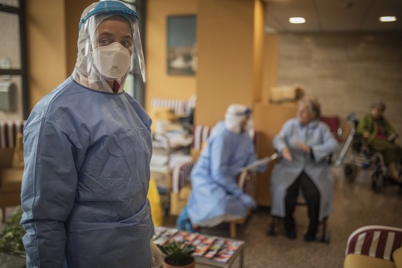 In this photo taken on Wednesday April 1, 2020, Aid workers from the Spanish NGO Open Arms carry out coronavirus detection tests on the elderly at a nursing home in Barcelona, Spain. The initiative is ...