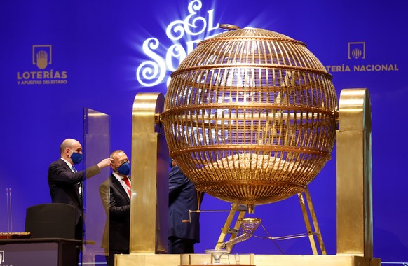 epa09653339 View of the rotating lottery drum before the start of El Gordo traditional Spanish Christmas Lottery draw held in the Royal Theater in Madrid, Spain, 22 December 2021. The traditional Span ...