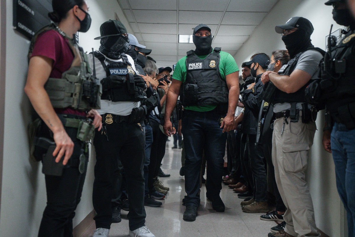 FILE - Masked federal agents wait outside an immigration courtroom, July 8, 2025, in New York. (AP Photo/Olga Fedorova, File)
New York ICE Mask Lawsuit