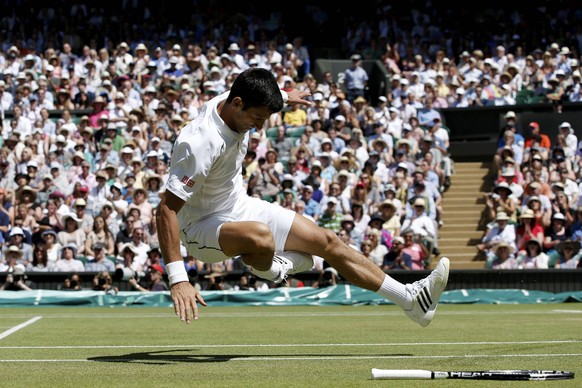 Novak Djokovic of Serbia falls over during his match against Richard Gasquet of France at the Wimbledon Tennis Championships in London, July 10, 2015. REUTERS/Adrian Dennis/Pool